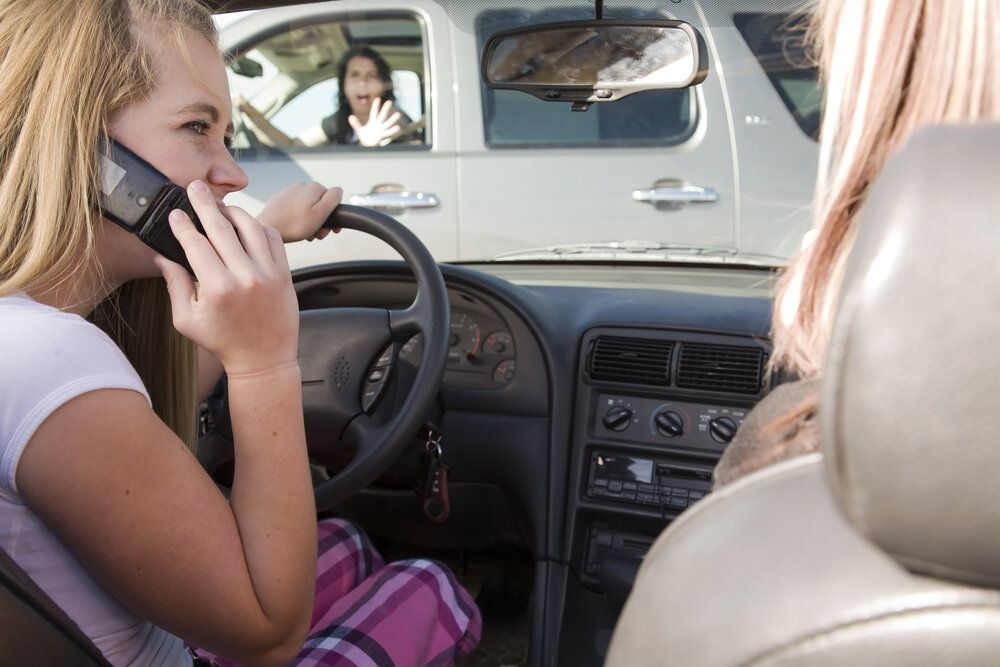 woman on cellphone while driving