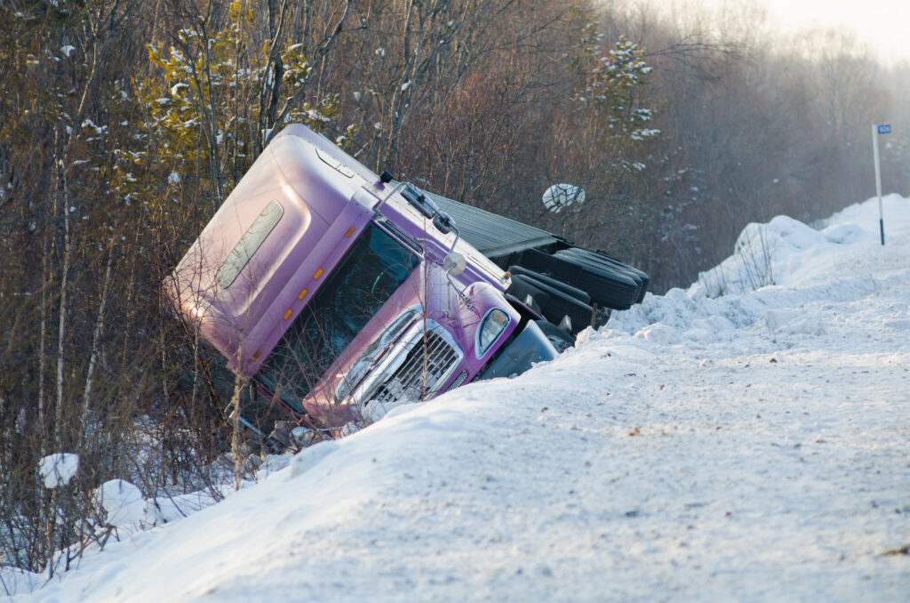 Truck accident in snow and ice on a Maine highway during winter conditions